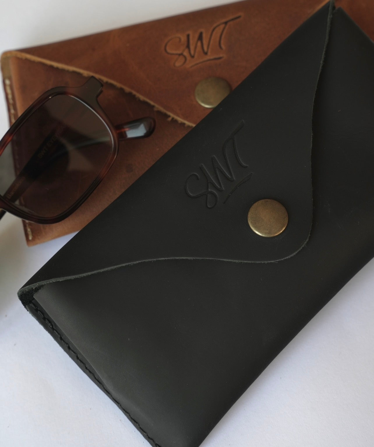 SWT leather sunglasses cases in brown and black buffalo leather