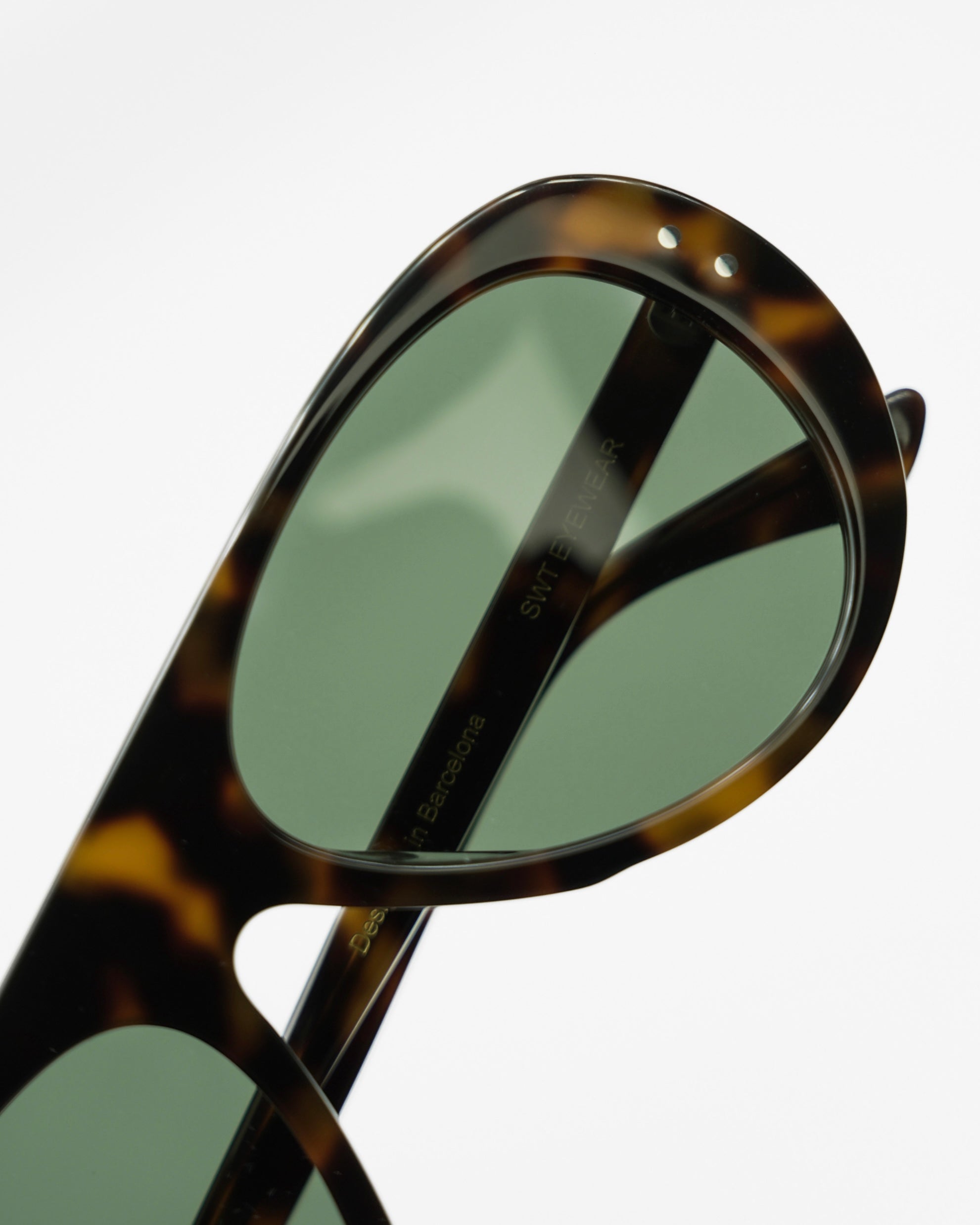 Miglia sunglasses by SWT, dark tortoiseshell aviator with green lenses, three-quarter view