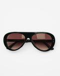 Reserve sunglasses by SWT, black aviator frame with burgundy gradient lenses, front view