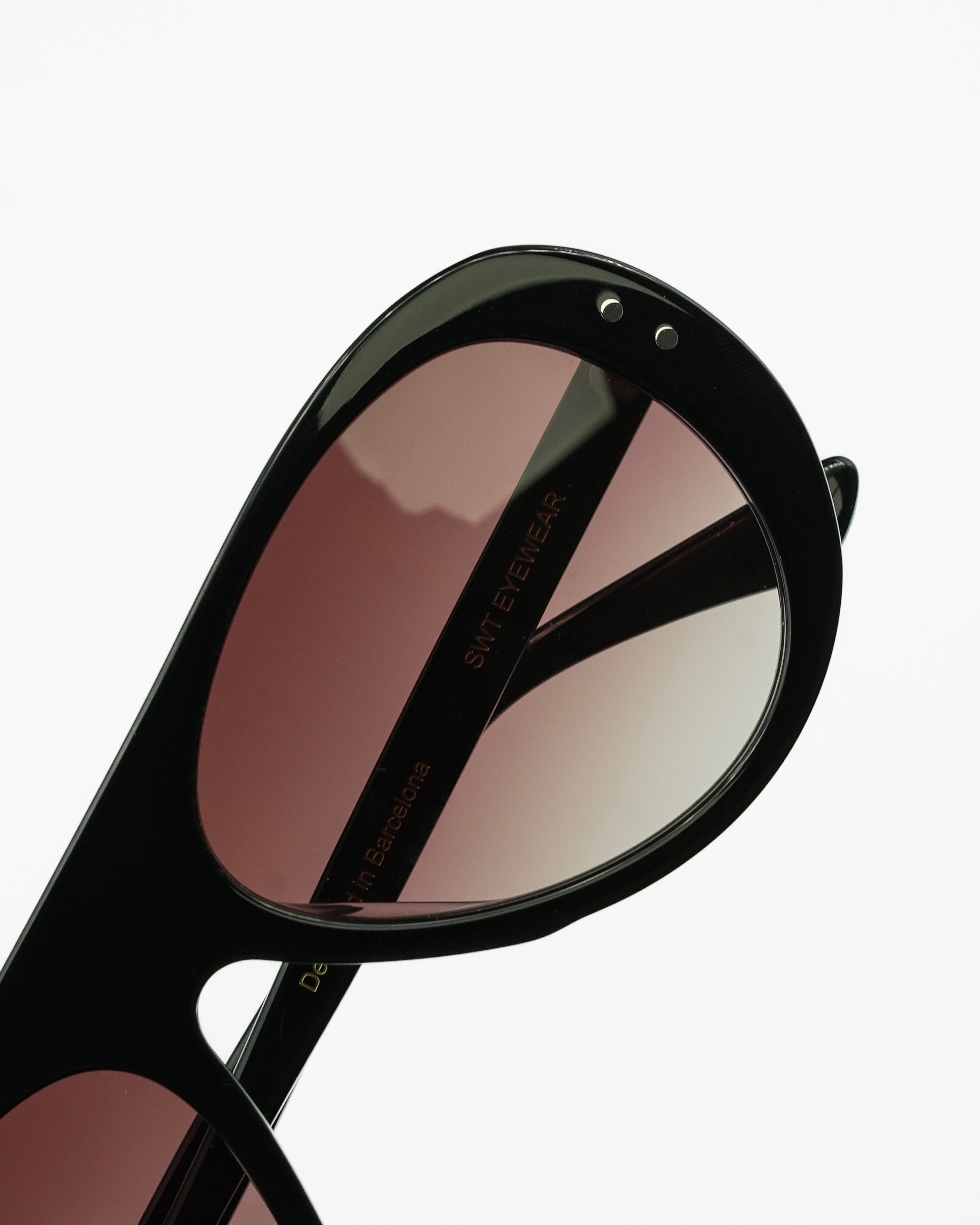 Reserve sunglasses by SWT, black aviator with burgundy lenses, three-quarter view