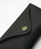 SWT black leather sunglasses case, open with sunglasses inside